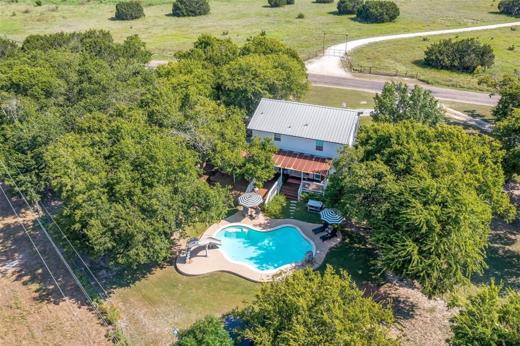 an aerial view of a house with yard swimming pool and outdoor seating