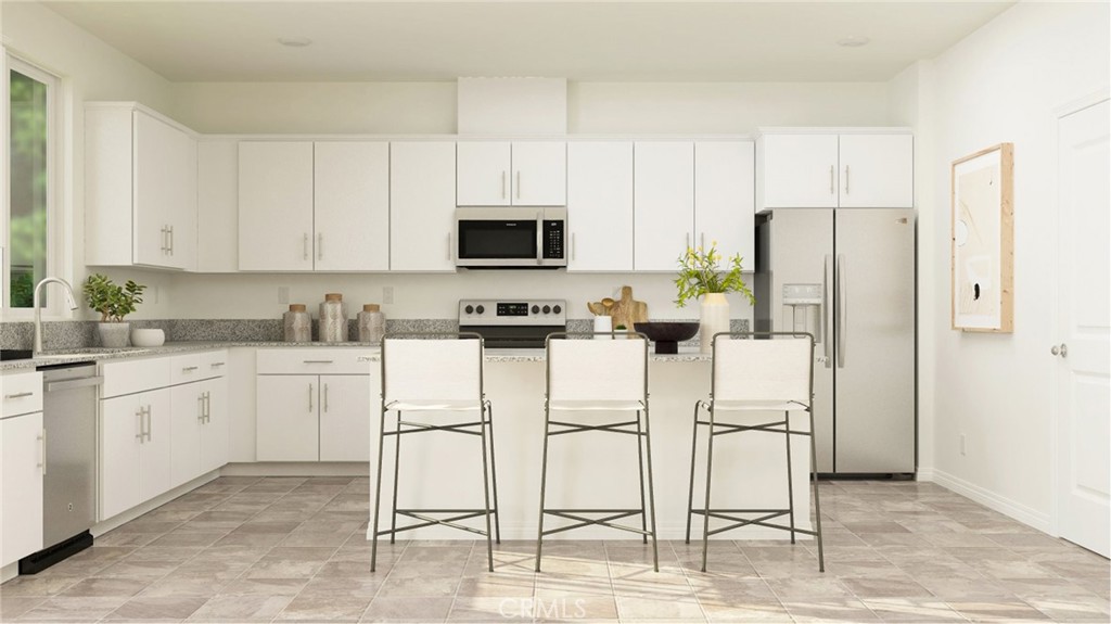 a kitchen with appliances cabinets and furniture