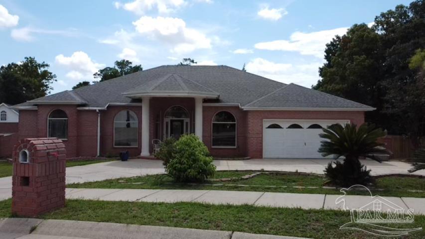 a front view of a house with garden