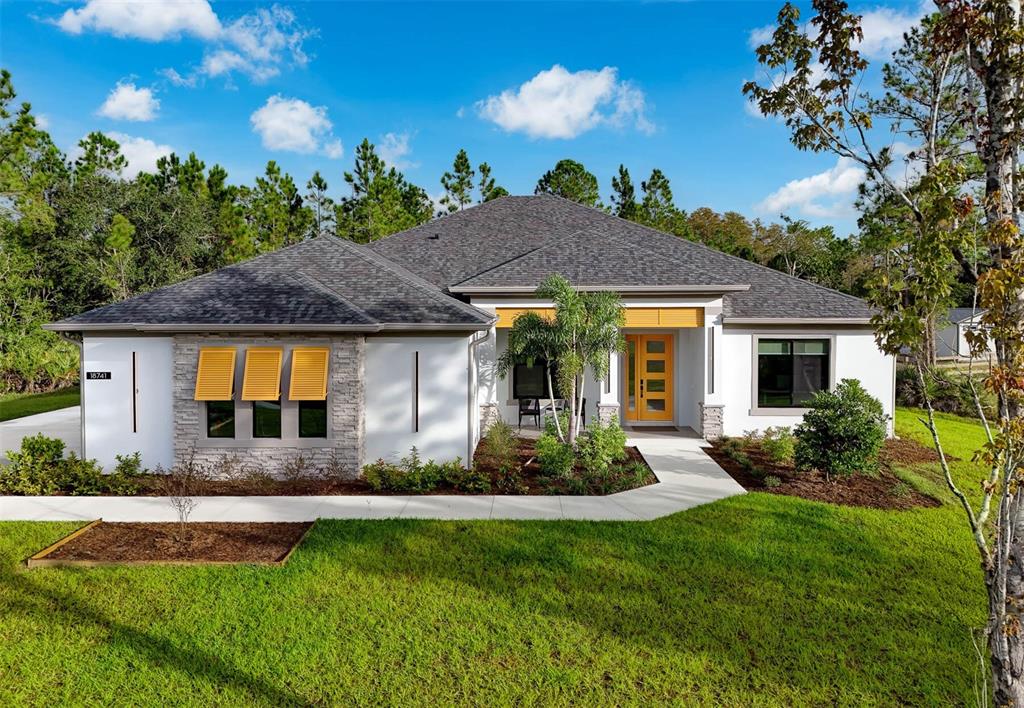 a front view of house with yard and outdoor seating