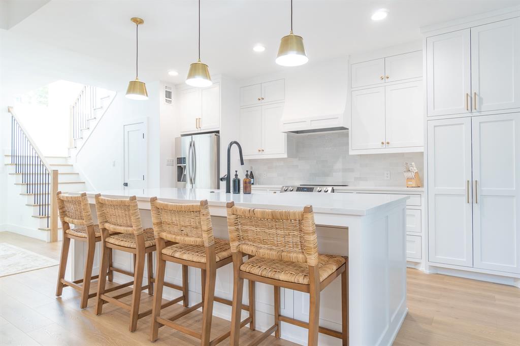 a kitchen with kitchen island granite countertop a table and chairs in it