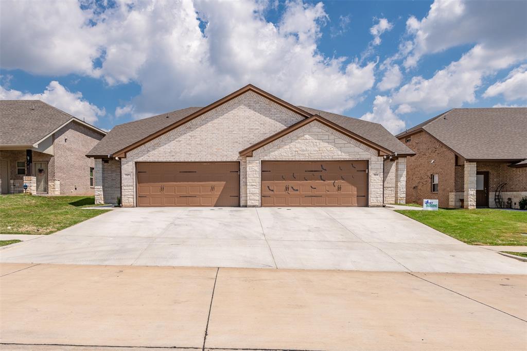 a front view of a house with yard and garage