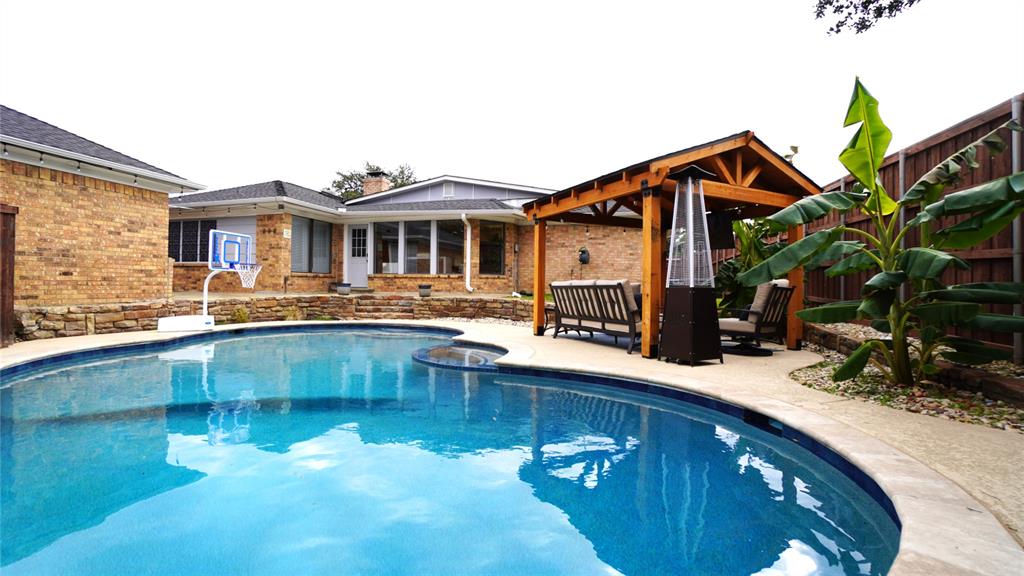 a view of a house with pool and chairs