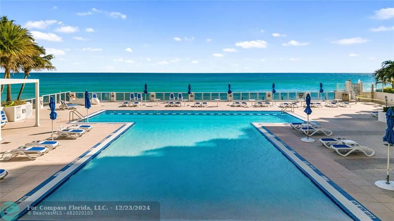 a view of a swimming pool with furniture