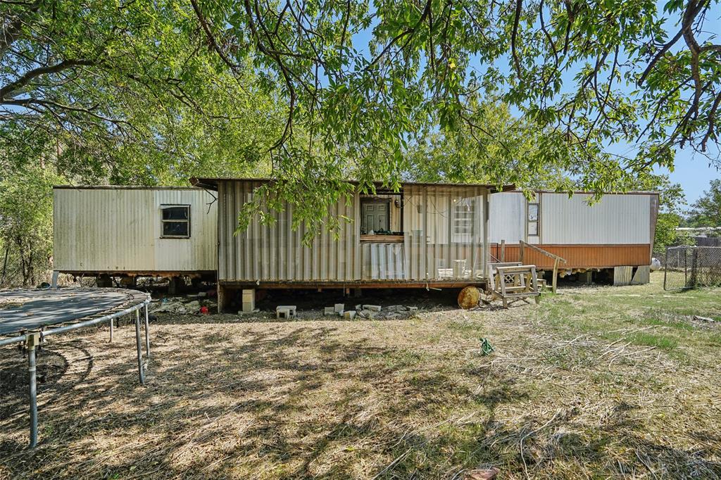 a backyard of a house with shaded area