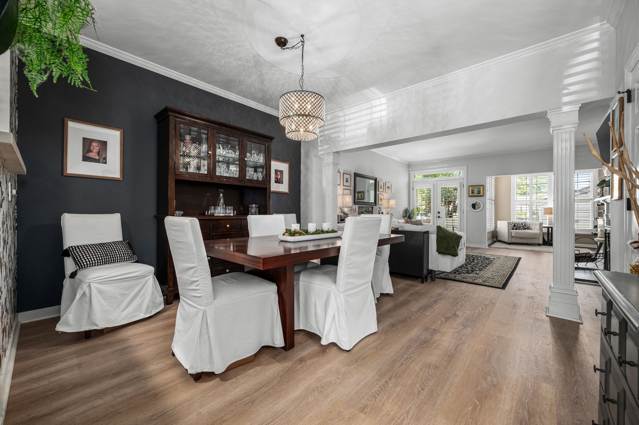 Enter from the foyer into the Formal dining room open to the living room perfect for open flow and entertaining yet separated by pillars to provide a dedicated space for meals and keeping kitchen clutter out of sight.