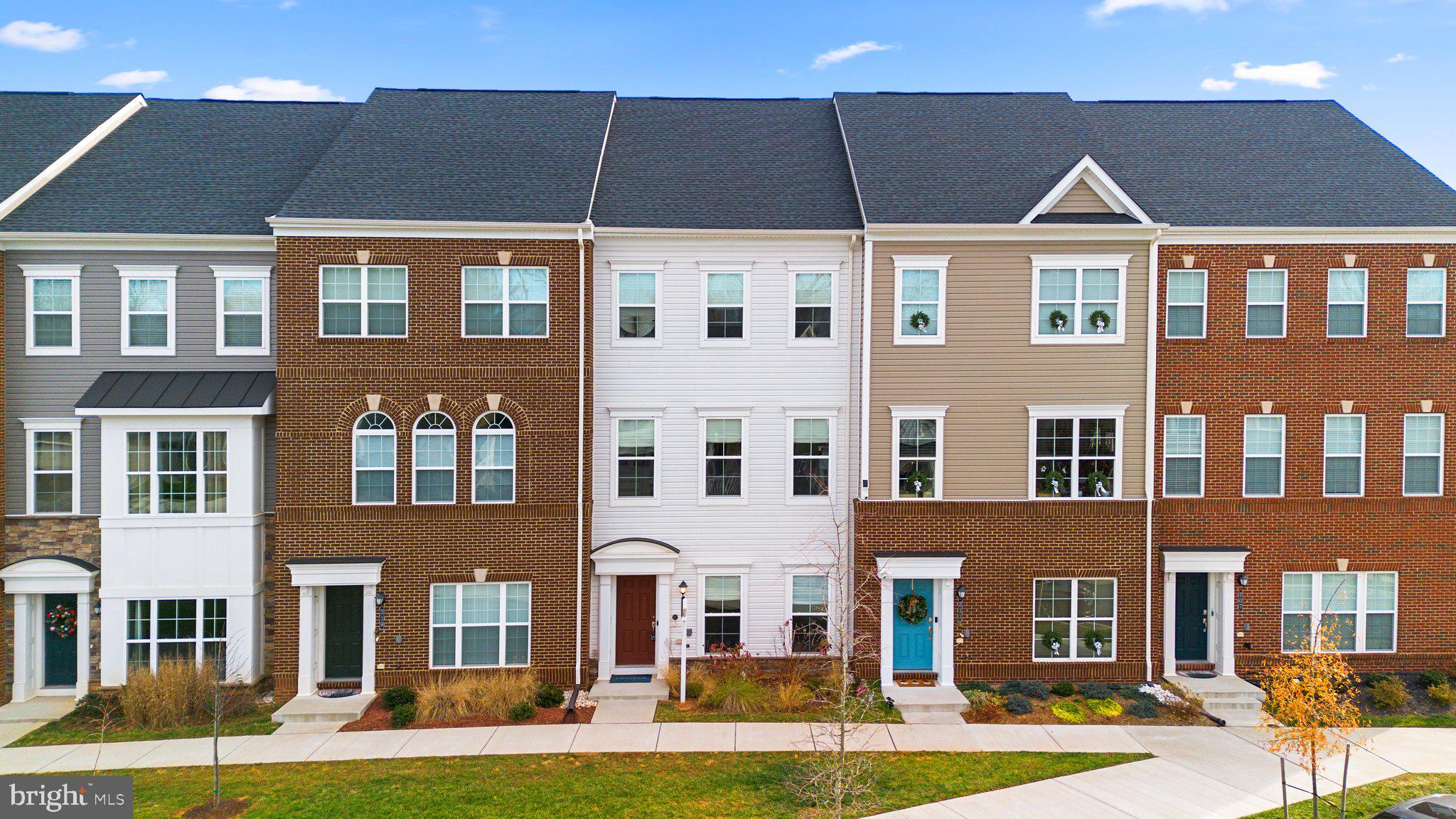 front view of a residential apartment building with a yard