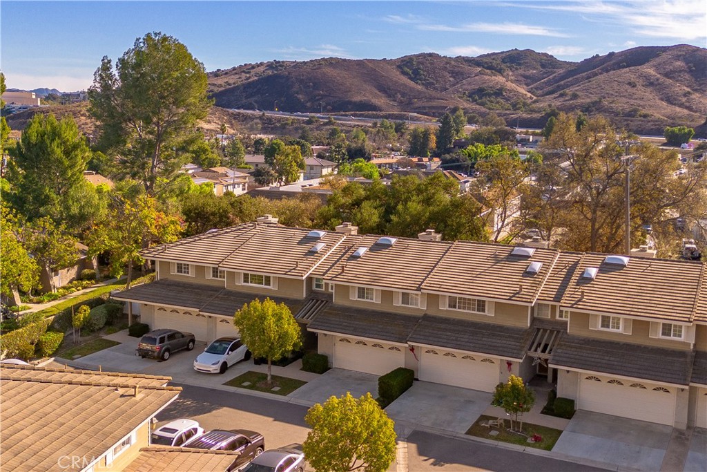 an aerial view of a houses with a mountain