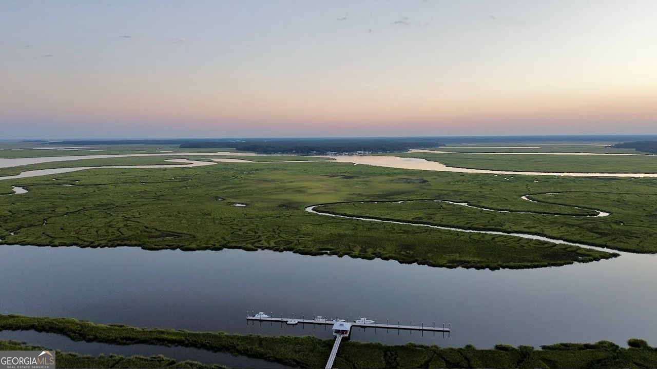 an aerial view of a golf course with a lake view