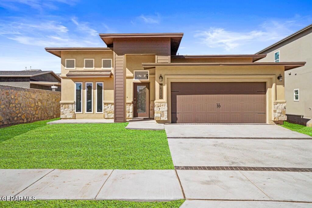 a front view of a house with a yard and garage