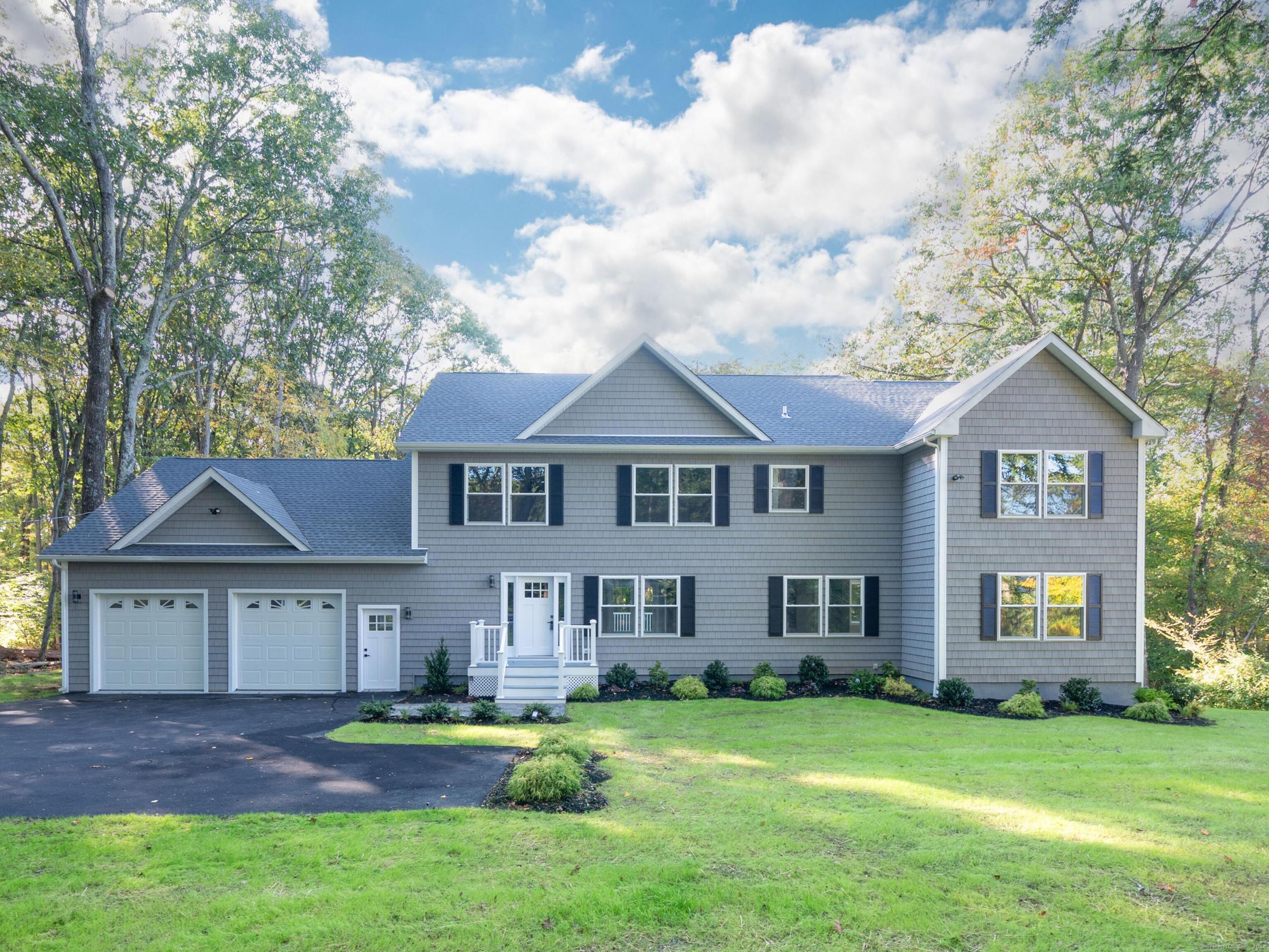 a front view of a house with a yard and garage