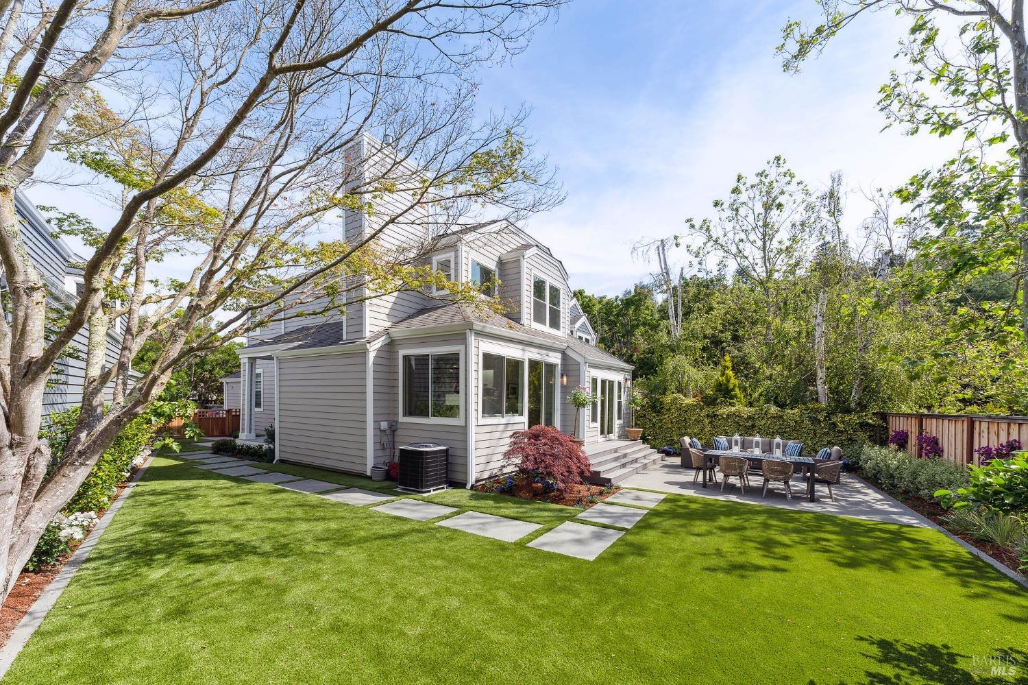 a view of a house with backyard porch and sitting area