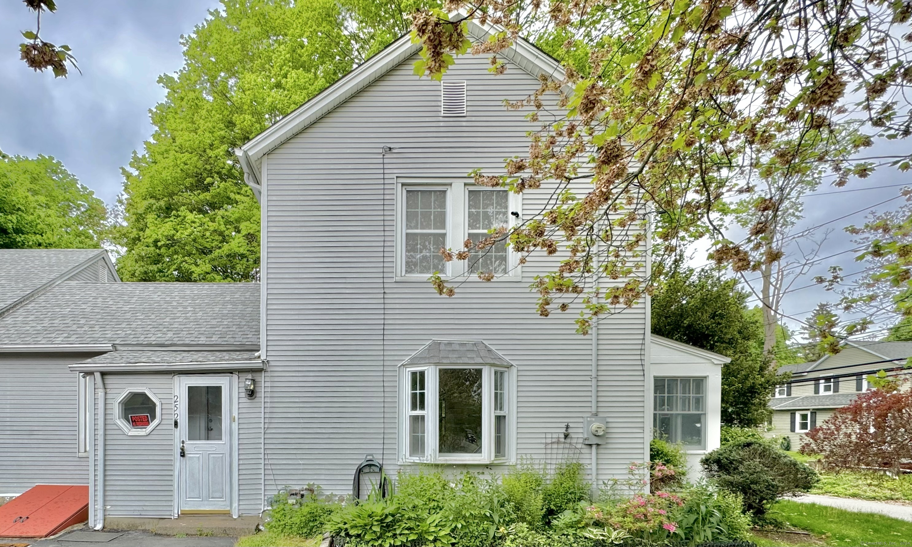 a front view of a house with garden