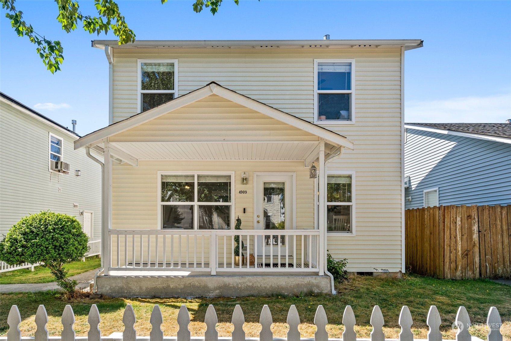 a view of a house with wooden fence