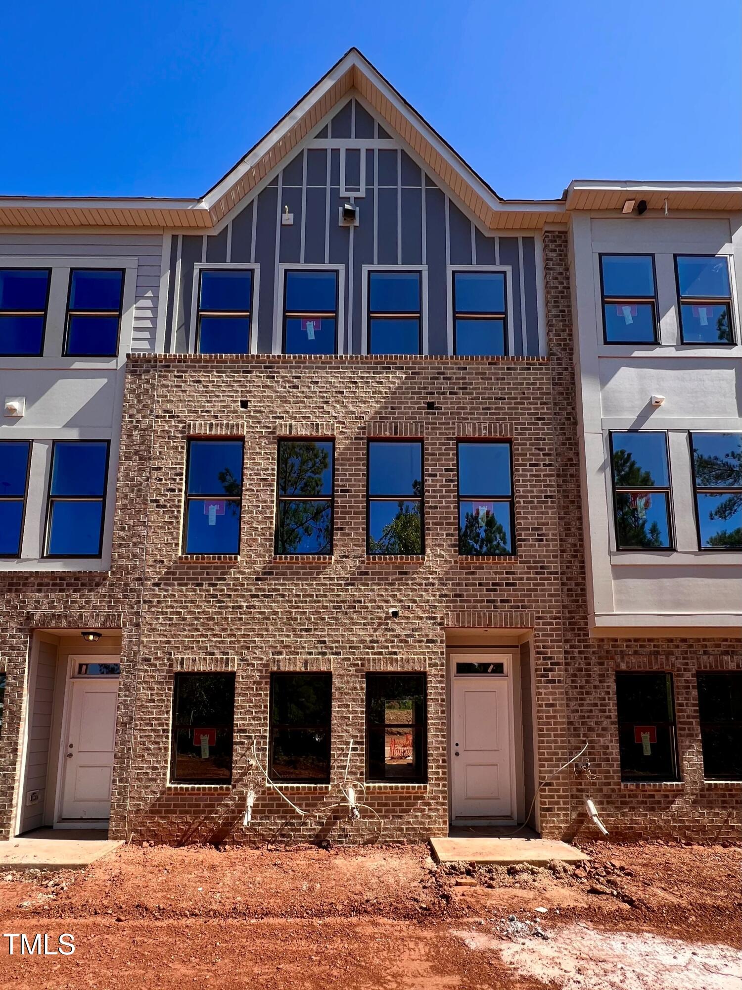 a front view of a brick house with large windows