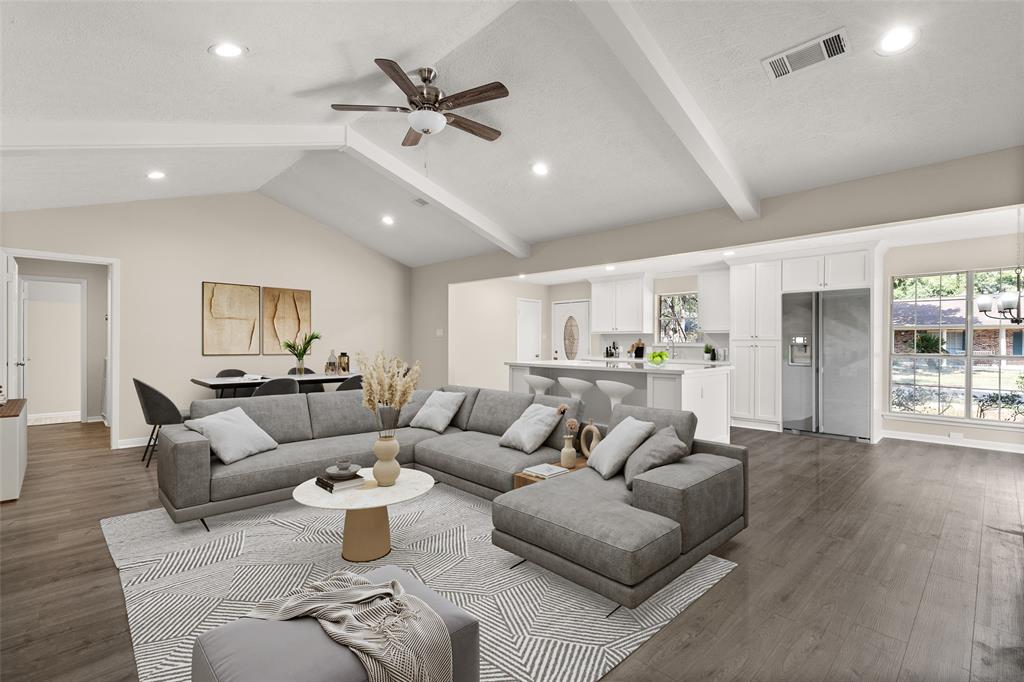 a living room with furniture and wooden floor