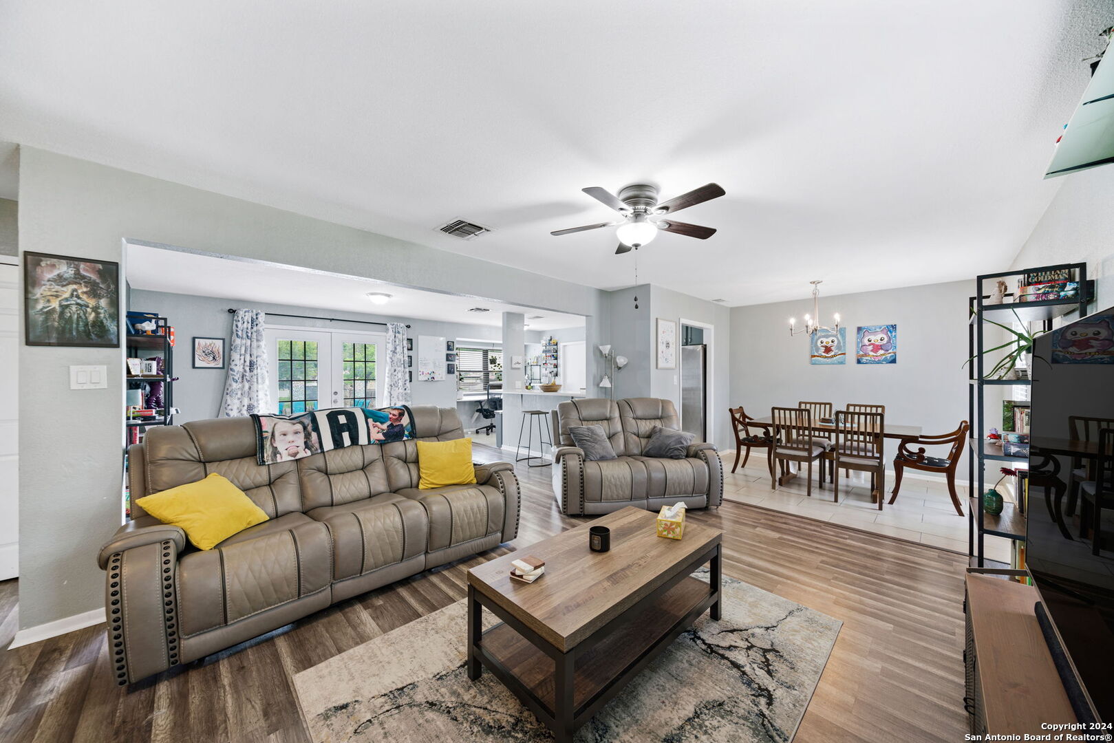 a living room with furniture and wooden floor