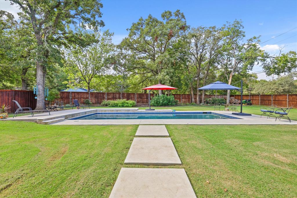 a view of swimming pool with sitting area and furniture