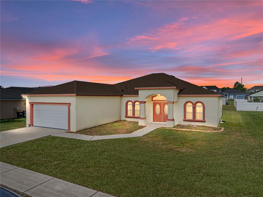 a front view of a house with a yard and garage