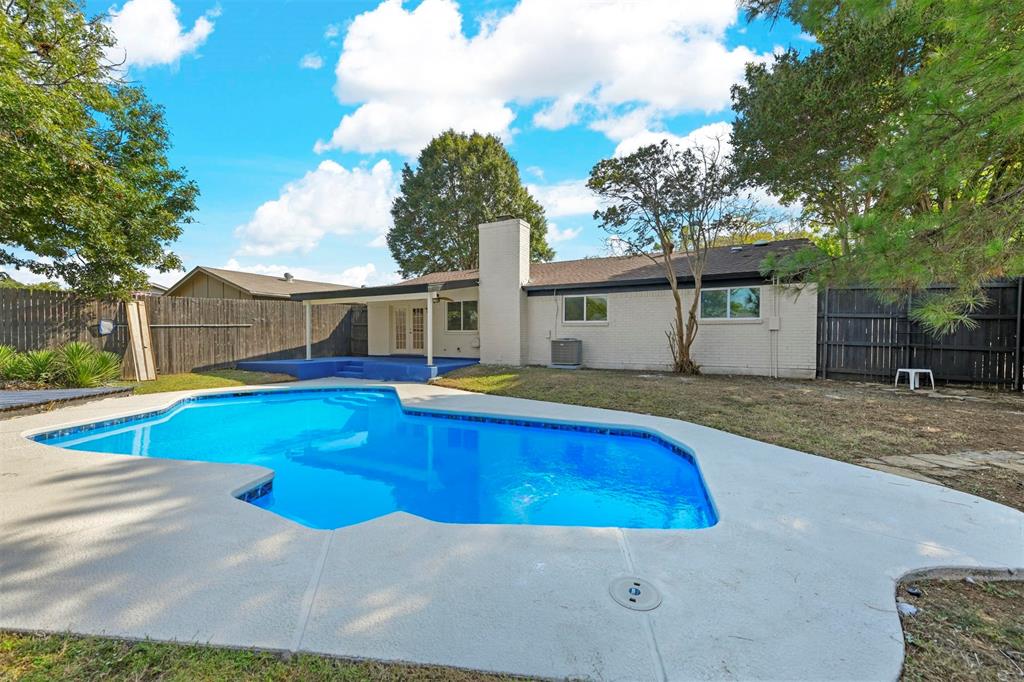 a view of a house with a swimming pool and a yard