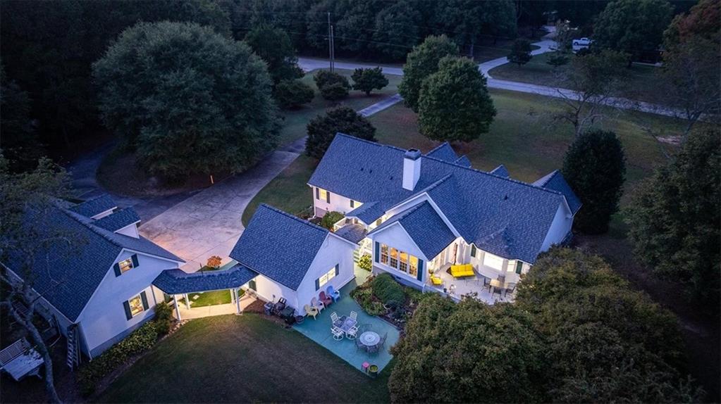 an aerial view of a house with garden space and street view