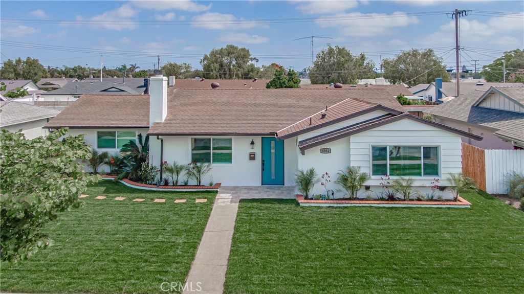 a front view of a house with a garden and patio