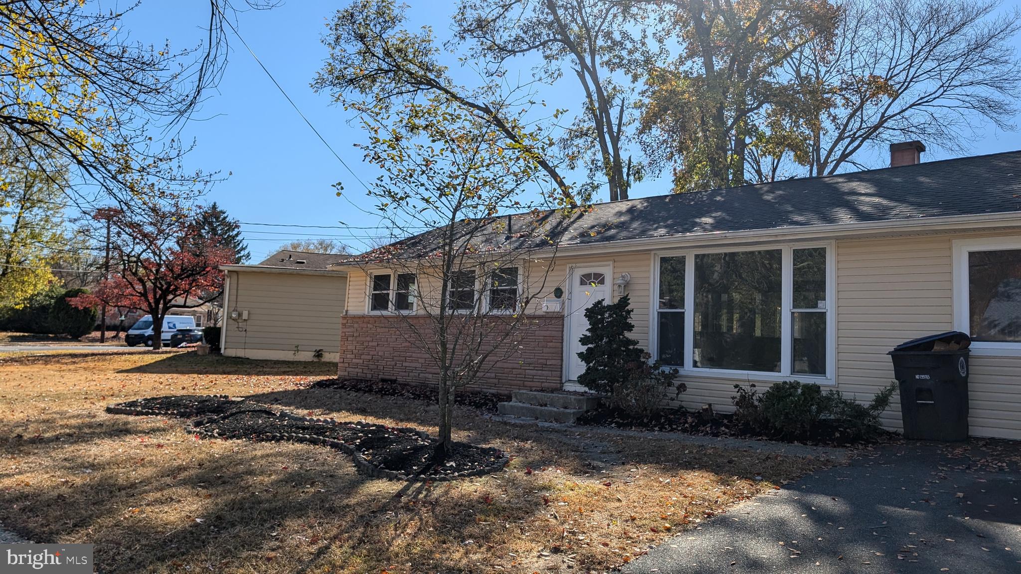 a view of a house with a yard covered with trees