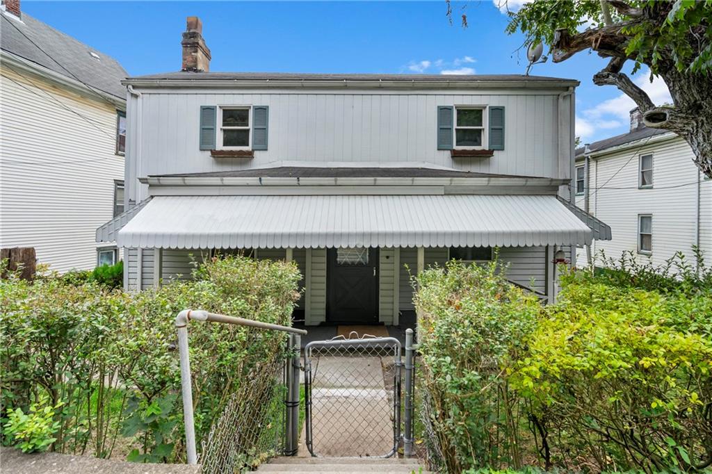 front view of a house with a garden