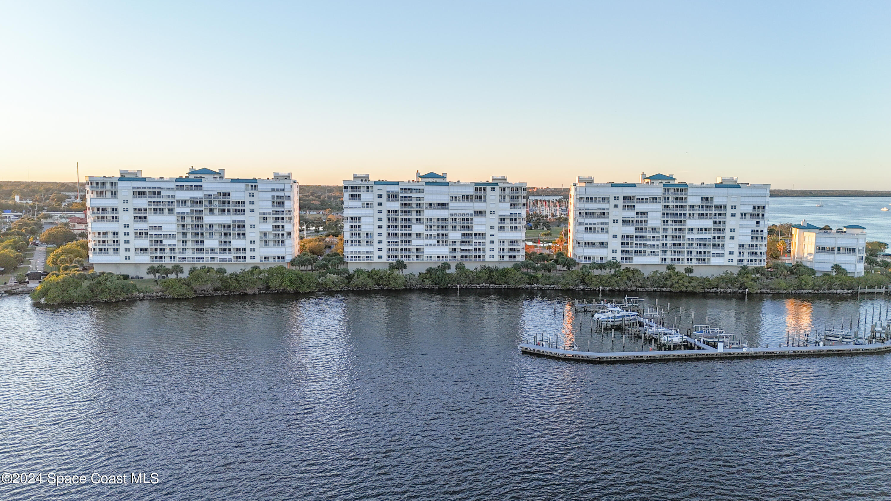 a view of a lake with tall building in the background