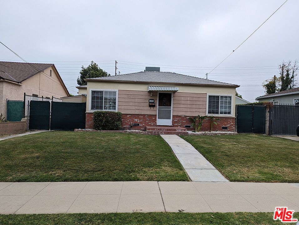 a front view of house with a garden