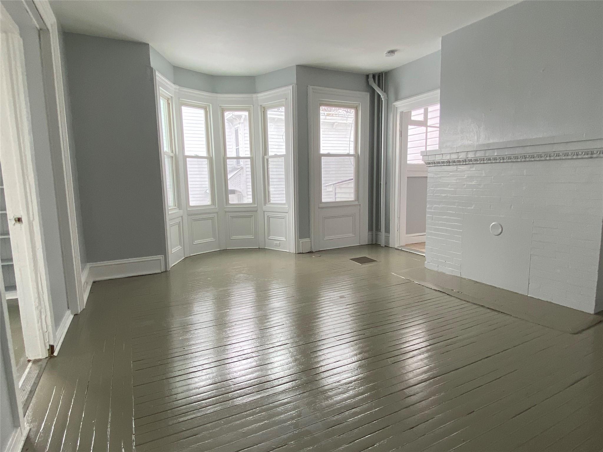 Living room featuring a fireplace and dark wood-type flooring