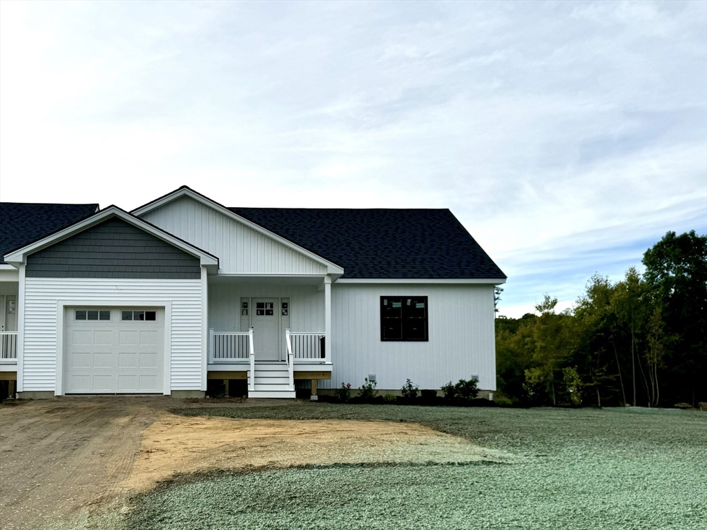 a view of a house with yard in front of it