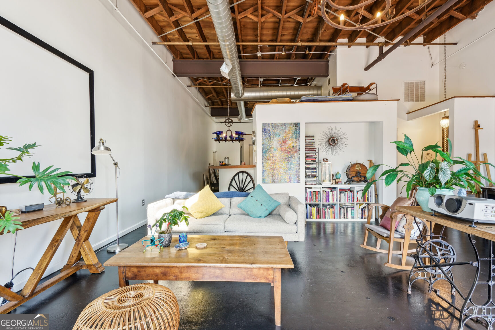 a living room with lots of furniture and a chandelier