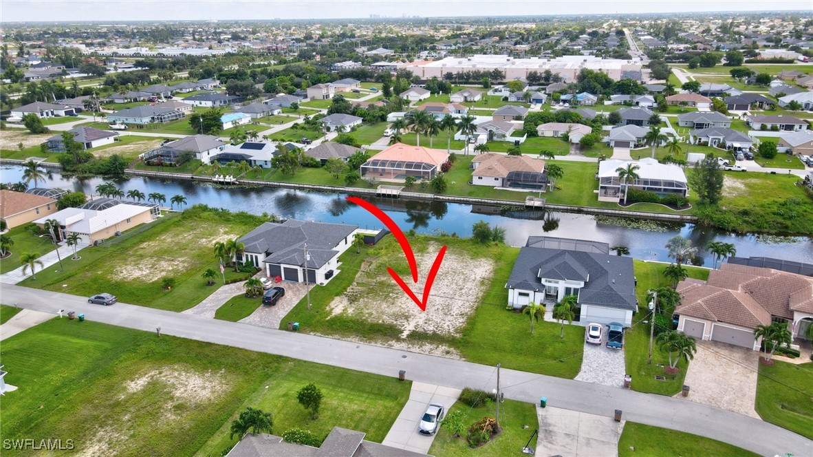 an aerial view of residential houses with outdoor space and swimming pool