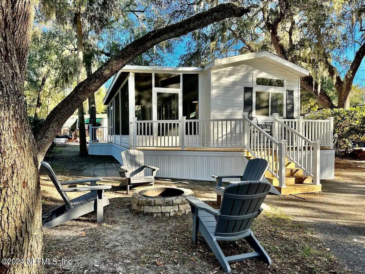 a front view of a house with outdoor seating