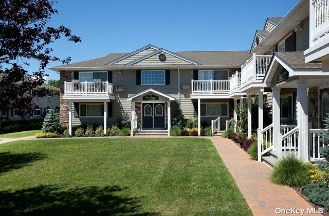 a front view of a residential apartment building with a yard