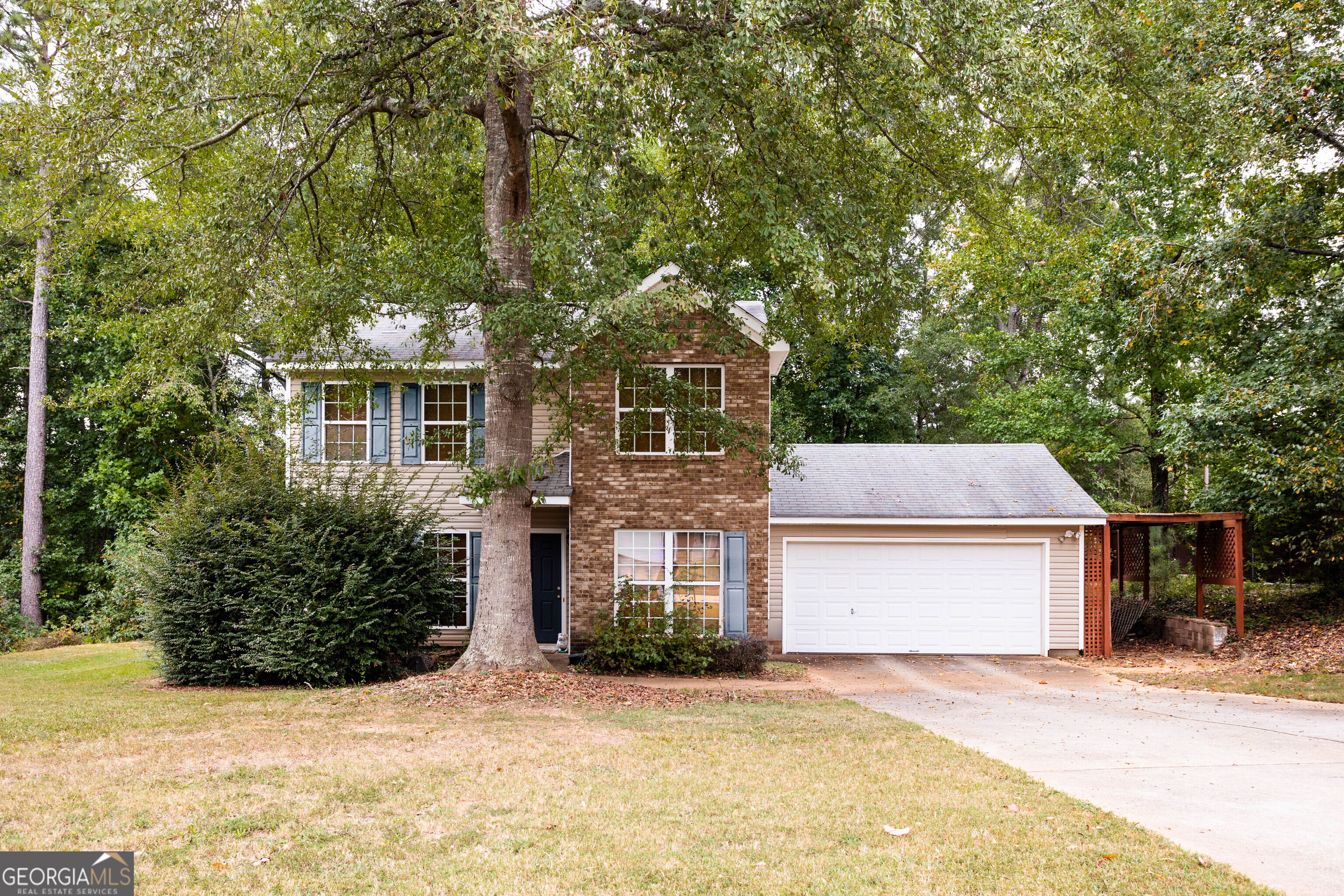 a front view of a house with a yard and garage