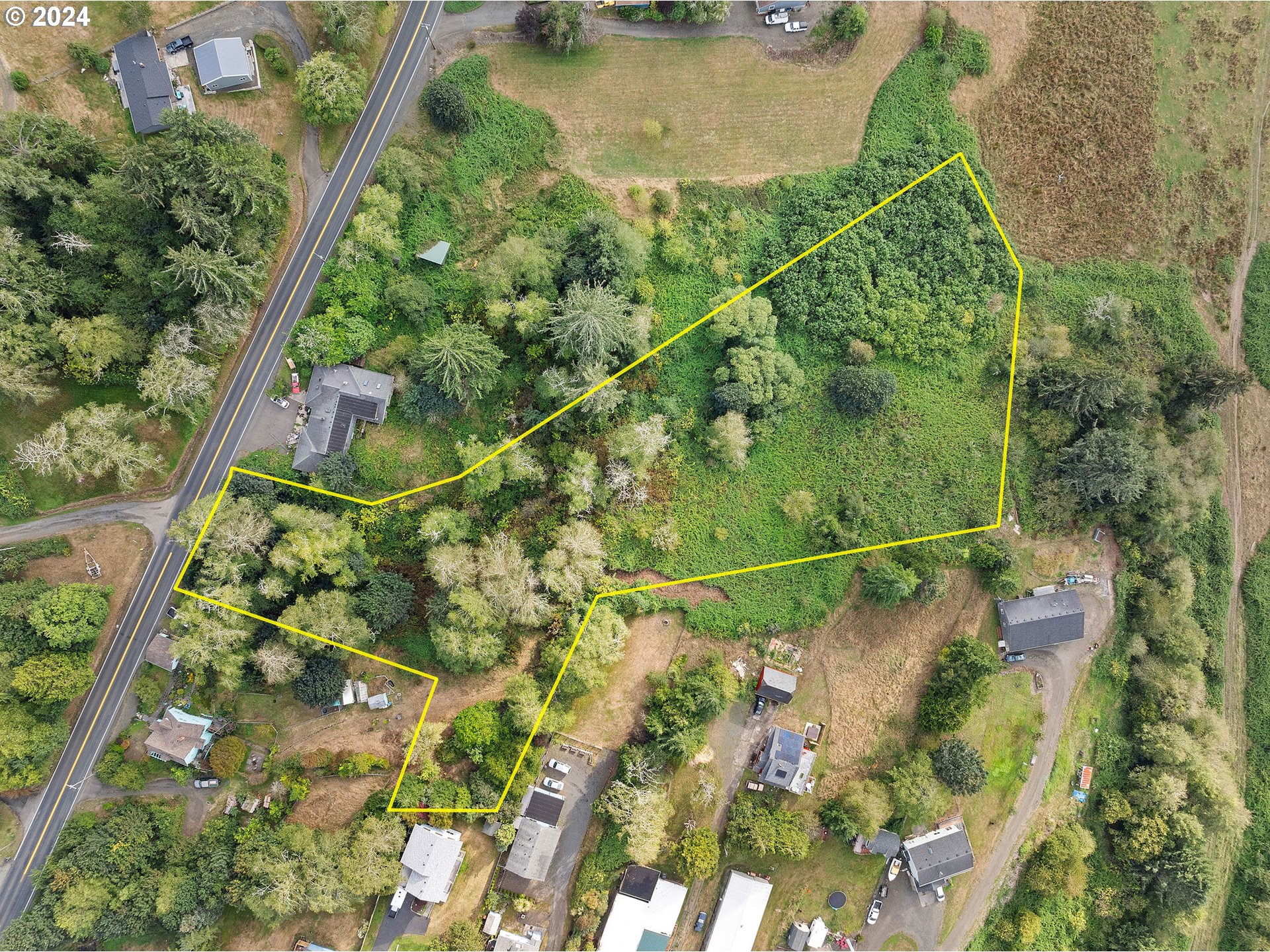 an aerial view of a residential houses with outdoor space