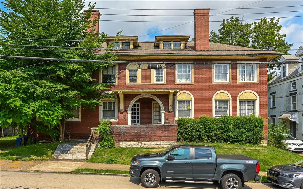 a front view of a house with a garden