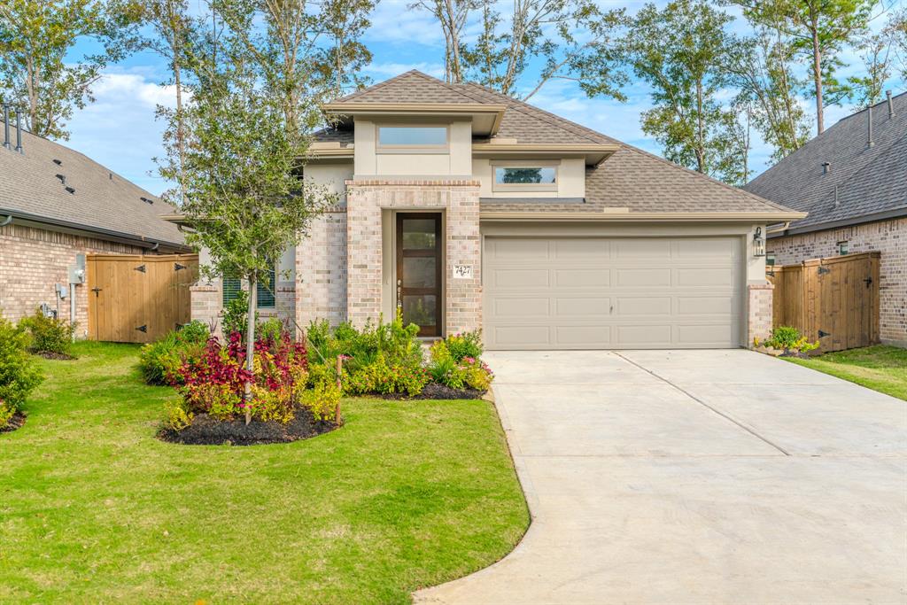 a front view of house with a garden