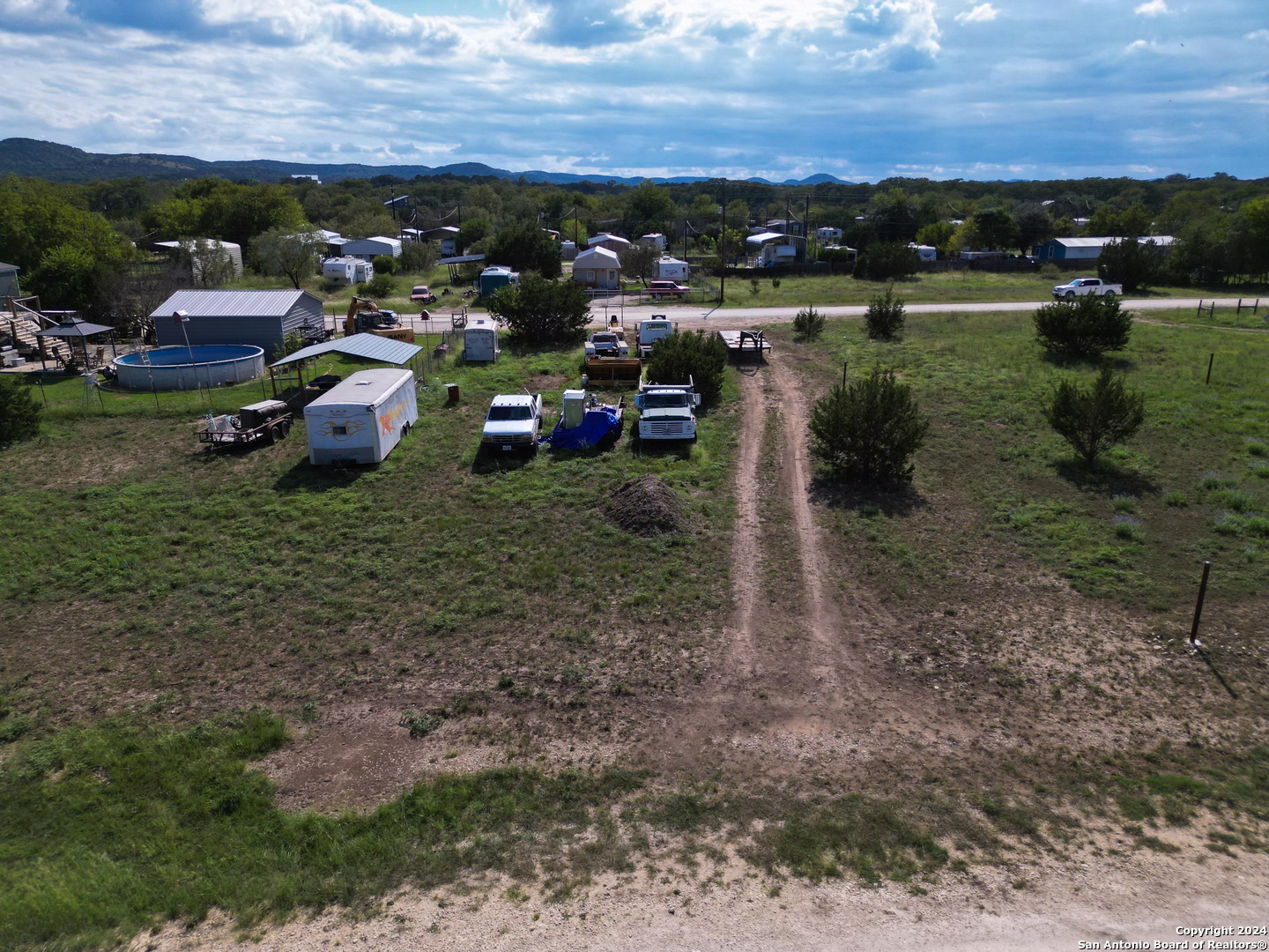 a view of a lake with multiple cars parked