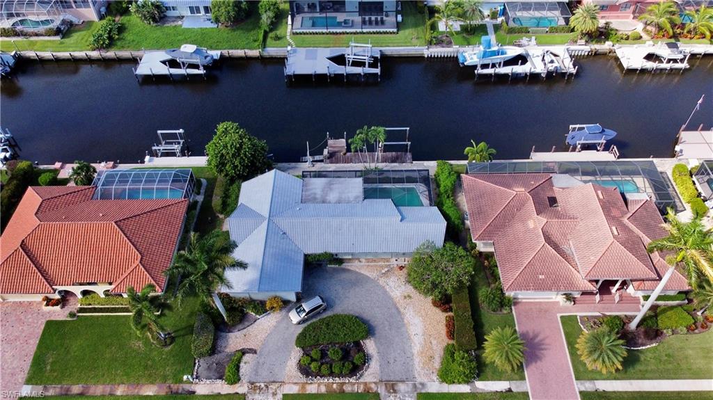 an aerial view of a house with a swimming pool patio and outdoor seating