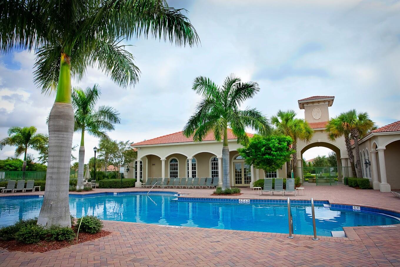 a view of house with outdoor space and swimming pool