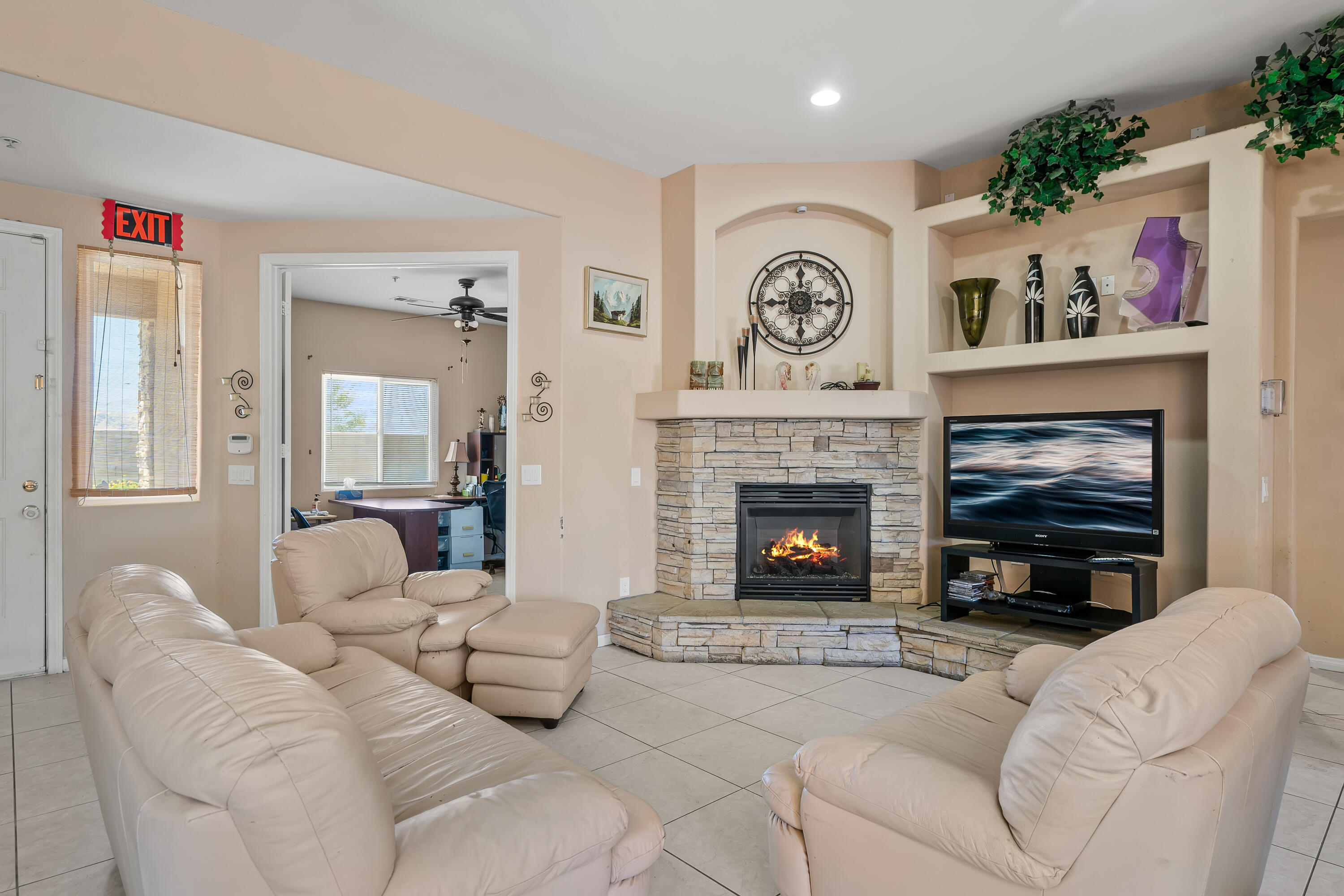 a living room with furniture a clock and a fireplace