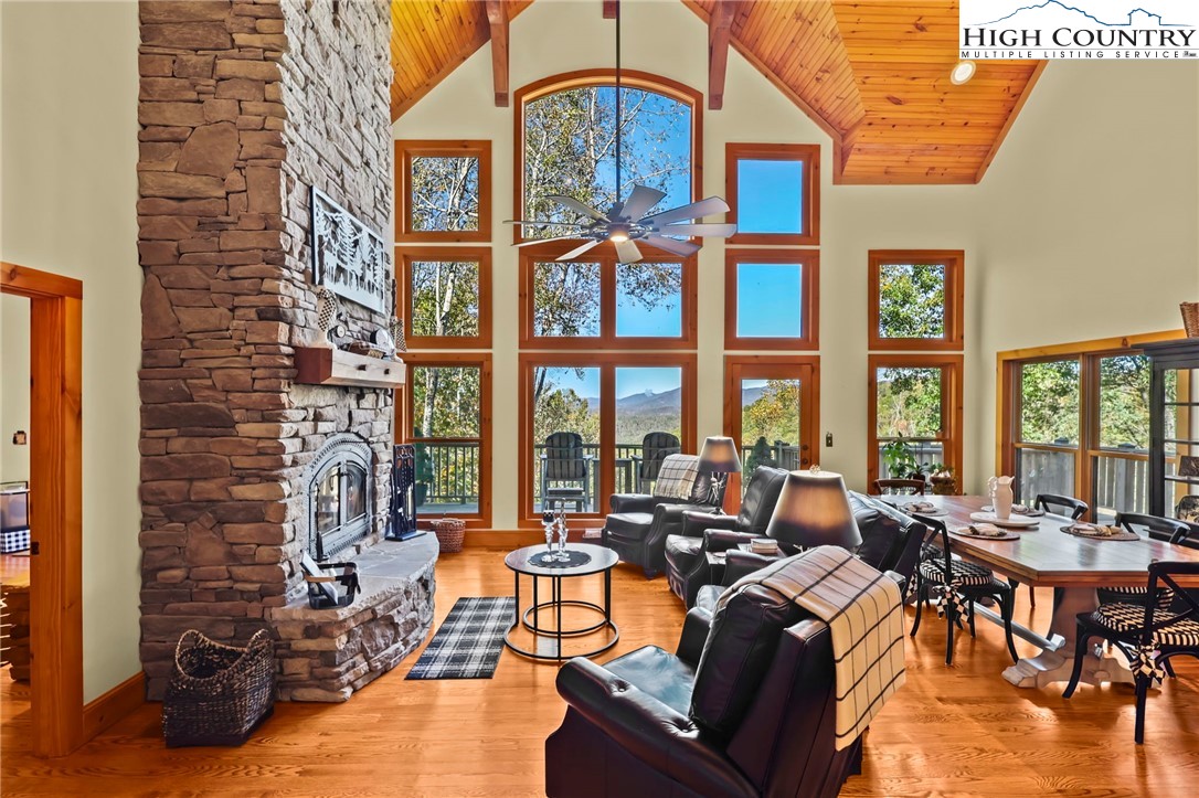 a living room with fireplace furniture and a large window