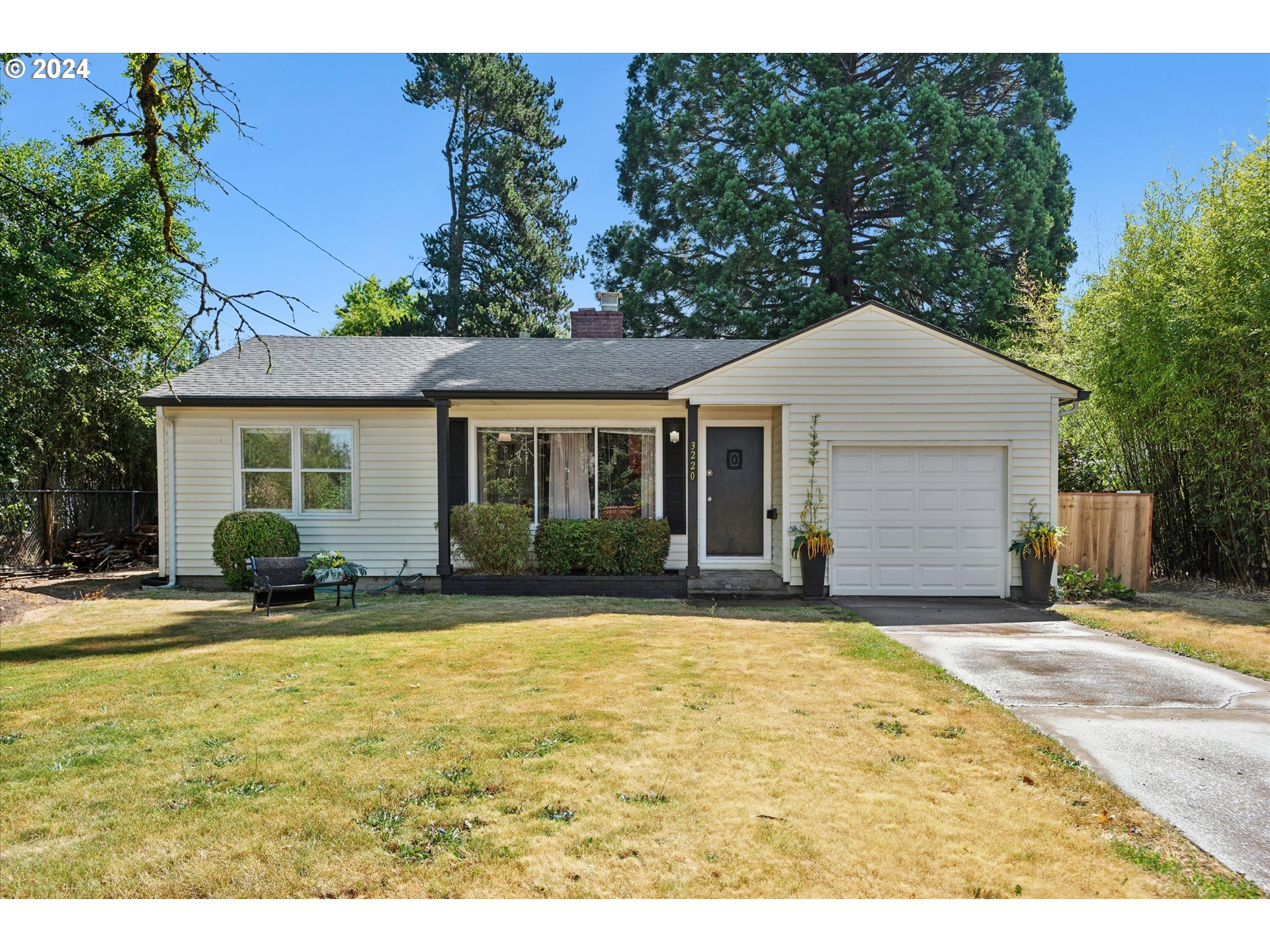 a front view of a house with yard and green space