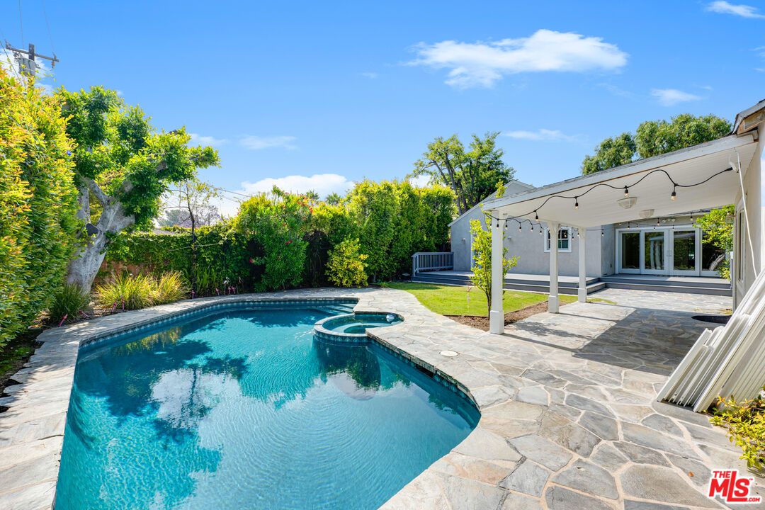 a view of a house with swimming pool and sitting area