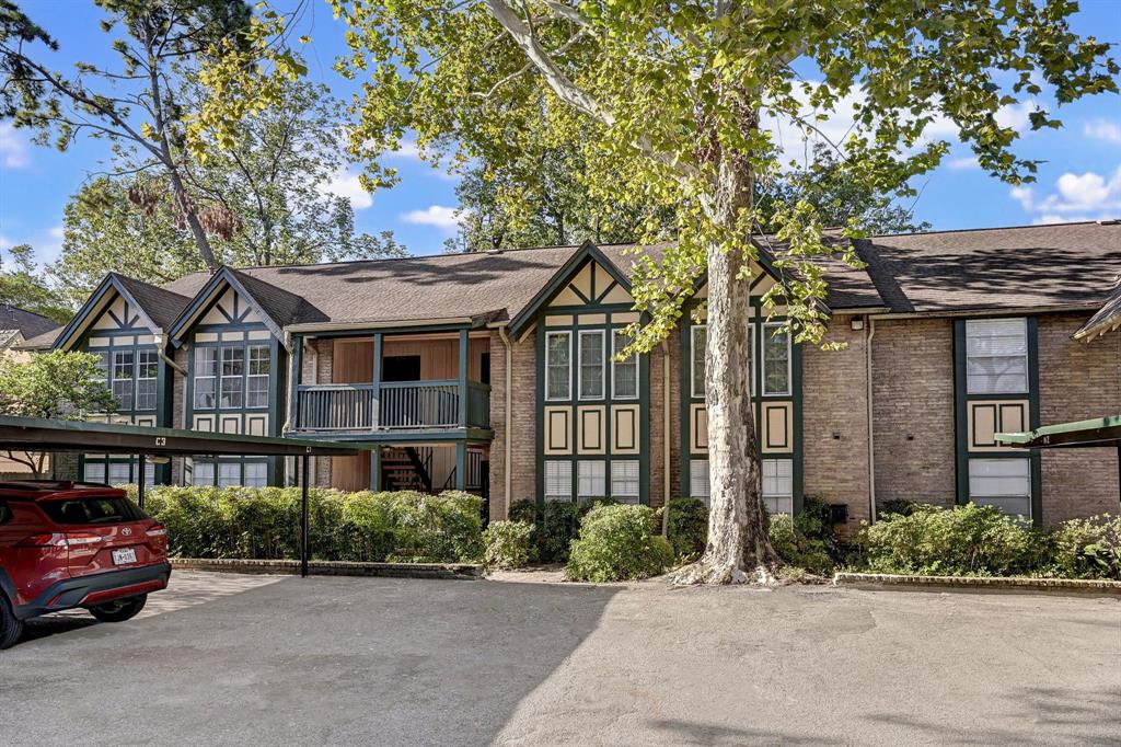 front view of a brick house with a yard