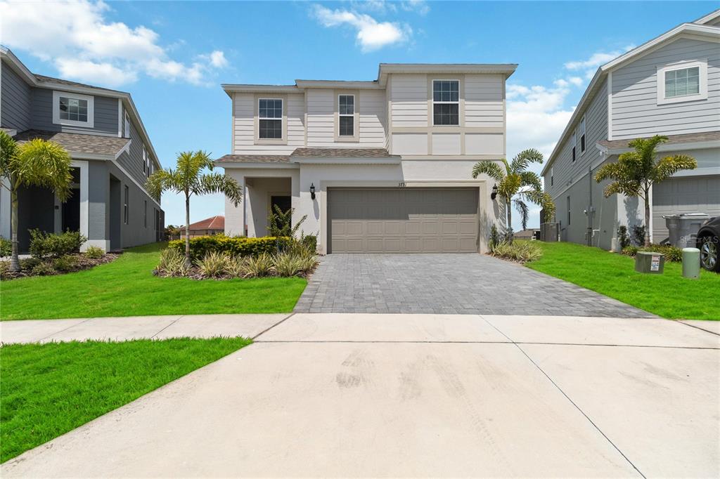 a front view of a house with a yard and garage