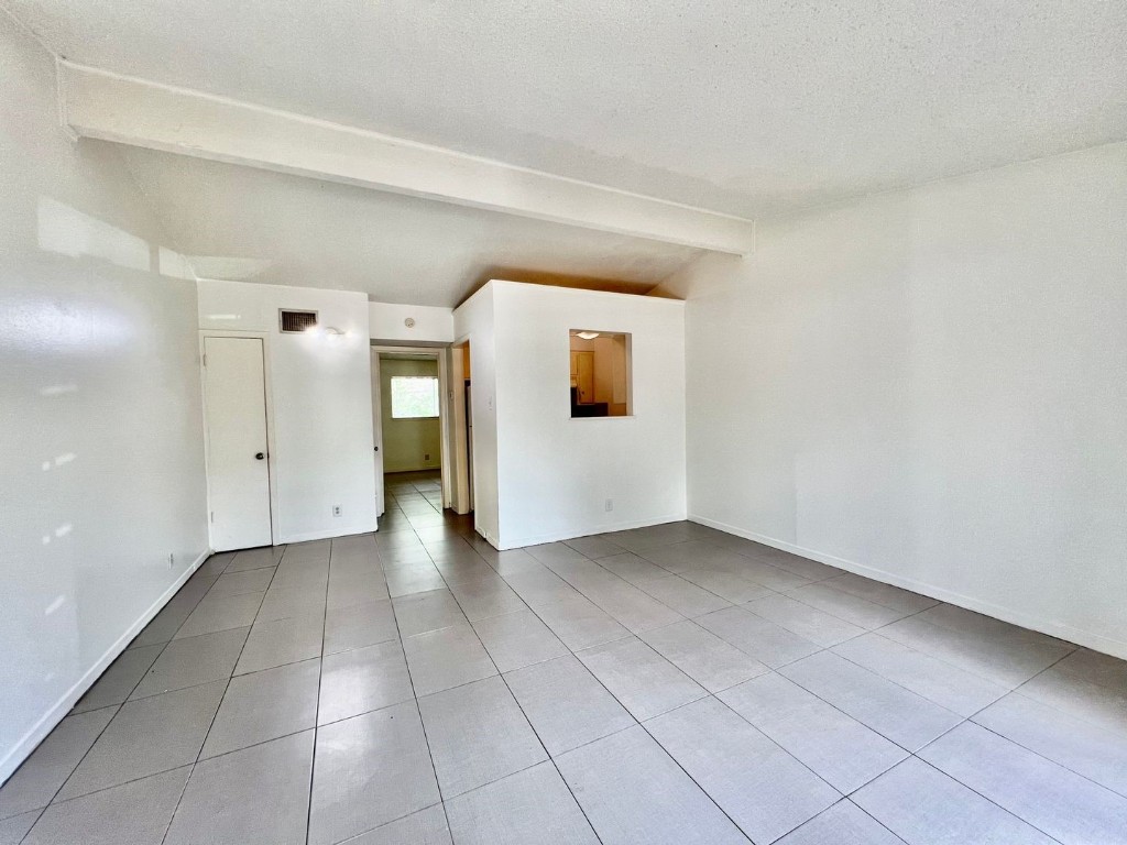 a view of a big room with closet and windows